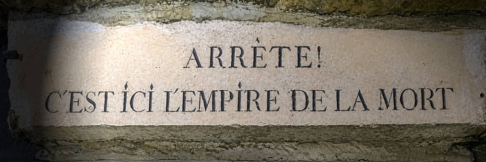 The famous Stop! This is the Empire of the Death sign at the entrance of the Paris Catacombs ossuary